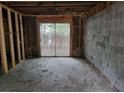 Unfinished basement with exposed framing and a sliding glass door to the backyard at 4701 Flat Shoals Rd # 56D, Union City, GA 30291