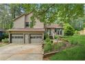Charming home featuring a two-car garage, landscaped yard, and welcoming front porch at 1149 Midland Nw Dr, Acworth, GA 30102