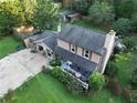 An aerial shot of the home showcases the backyard patio, mature trees, and surrounding greenery at 4364 Saddlecreek Ct, Auburn, GA 30011