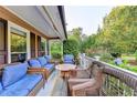 Relaxing outdoor porch area complete with comfortable seating arrangements, overlooking a serene front yard at 4364 Saddlecreek Ct, Auburn, GA 30011