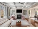 Open living room with coffered ceilings, fireplace, and french doors leading to the outside at 540 Woodall Ne Ave, Atlanta, GA 30306