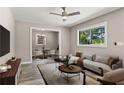 Inviting living room featuring contemporary furniture, a ceiling fan, and large windows at 2392 Jefferson Ter, Atlanta, GA 30344