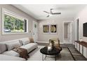 Bright living room with modern furnishings, stylish decor, and a large window overlooking a wooded area at 2392 Jefferson Ter, Atlanta, GA 30344