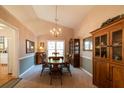 Elegant dining room with a chandelier, a large wooden table, and classic decor at 310 Morning Glen Dr, Suwanee, GA 30024