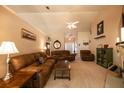 Spacious living room with comfortable sofas, a ceiling fan, and a view of the entryway at 310 Morning Glen Dr, Suwanee, GA 30024