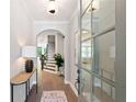 Bright foyer with hardwood floors, an elegant console table and a staircase leading to the upper level at 409 Retreat Ln, Canton, GA 30114