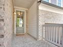 Inviting front porch with brick accents and a charming entryway, perfect for welcoming guests at 409 Retreat Ln, Canton, GA 30114