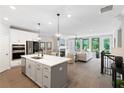 Spacious living space with a modern kitchen, dining area, living room and beautiful hardwood floors throughout at 409 Retreat Ln, Canton, GA 30114