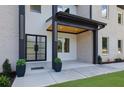 Inviting home entrance featuring a double glass door and accent lighting at 4881 Bill Cheek Rd, Auburn, GA 30011