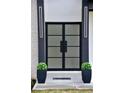 Up-close view of a home's elegant double glass door with modern lighting at 4881 Bill Cheek Rd, Auburn, GA 30011