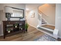 Inviting foyer showcasing hardwood floors, staircase, and stylish console table at 1412 Shelnutt Ct, Hampton, GA 30228