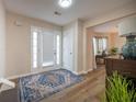 Bright foyer features a tiled floor, front door with sidelights, and elegant decor at 1412 Shelnutt Ct, Hampton, GA 30228