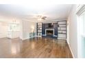 Spacious living room features a decorative fireplace, built-in shelving, and hardwood floors at 5873 Trellis Ct, Powder Springs, GA 30127