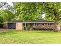 Brick home with updated accents, driveway and green front lawn at 991 Columbia Dr, Decatur, GA 30030