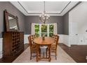A lovely dining area featuring an attractive chandelier, and a view to a verdant front yard at 1143 Brookhaven North Cir, Brookhaven, GA 30319