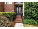 Elegant home entrance with brick steps and meticulously maintained landscaping at 1143 Brookhaven North Cir, Brookhaven, GA 30319