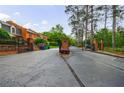 Community entrance with a gated entry and mature trees at 27306 Plantation Ne Dr, Atlanta, GA 30324