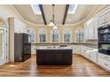 Spacious kitchen with a central island, stainless steel appliances, granite countertops, and lots of natural light at 2975 Coles Way, Atlanta, GA 30350
