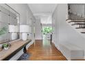 Inviting foyer with hardwood floors, elegant console table, and staircase at 3920 Cash Lndg, Marietta, GA 30066