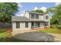 Charming two-story home with a new roof, siding, a driveway, and a lush green lawn at 1758 Bridgestone Ct, Marietta, GA 30066