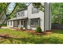 A two-story home with a covered porch and a well-maintained lawn creating a cozy curb appeal at 1758 Bridgestone Ct, Marietta, GA 30066