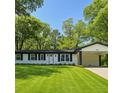 Beautiful single-story home boasts a lush green lawn, black trim, and a convenient covered carport at 2401 Winshire Drive, Decatur, GA 30035