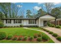 Charming home featuring manicured lawn, tasteful landscaping, and a convenient covered carport at 2401 Winshire Drive, Decatur, GA 30035