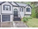 Stylish home entrance with a decorative window above the black front door and black trim at 405 Settlers Ridge Ln, Hiram, GA 30141