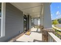 Charming covered front porch with gray siding, brick accents and a welcoming entrance at 9913 Stretford Rd, Douglasville, GA 30135