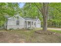 Charming one-story home with brick facade, covered porch, attached garage and mature trees at 1723 Ritcherson Se St, Marietta, GA 30060