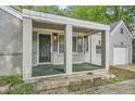 This one-story home features a covered front porch with brick columns and a single-car garage at 1723 Ritcherson Se St, Marietta, GA 30060