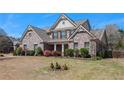 Beautiful brick home with a well-maintained lawn and landscape at 233 Millstone Pkwy, Woodstock, GA 30188