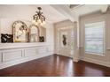 Elegant foyer with hardwood floors, decorative mirrors, and white trim at 233 Millstone Pkwy, Woodstock, GA 30188