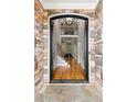 Grand foyer entrance with stone accents, soaring ceilings, and hardwood floors leads to second floor at 5826 Sarazen Trl, Douglasville, GA 30135