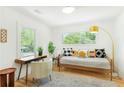 Cozy bedroom featuring a daybed, desk, and neutral decor accented with natural light from two windows at 1042 Oakdale Se Dr, Smyrna, GA 30080