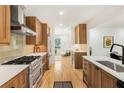 Modern kitchen boasts stainless steel appliances, custom wood cabinets, and light countertops at 1042 Oakdale Se Dr, Smyrna, GA 30080