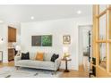 Bright living room with comfortable seating, modern decor, and natural light streaming through a nearby door at 1042 Oakdale Se Dr, Smyrna, GA 30080