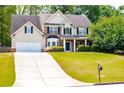 Beautiful two-story home with lush green lawn, traditional design, and inviting curb appeal at 210 Creekside Overlook, Hiram, GA 30141