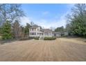 Expansive view of the home's rear exterior showcasing a large lawn and multi-level deck at 3167 Bay View Dr, Jonesboro, GA 30236