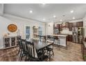 Open concept dining area with an island, stainless steel appliances, and modern lighting at 821 Ethereow Ct, Lawrenceville, GA 30046