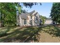 Charming two-story traditional home featuring manicured lawn and mature trees at 120 Julia Ct, Fayetteville, GA 30214