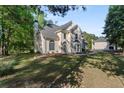 Charming two-story home with well-kept lawn and mature trees at 120 Julia Ct, Fayetteville, GA 30214