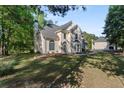 Charming two-story home featuring a well-manicured front lawn and mature trees at 120 Julia Ct, Fayetteville, GA 30214