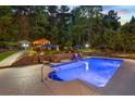 Inviting pool area features a sundeck, lounge chairs, and a charming pergola for entertaining at 2439 Huntington Park Nw Dr, Acworth, GA 30101