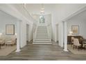 Bright foyer boasts soaring ceilings, a grand staircase, and beautiful flooring at 515 Old Chartwell Xing, Alpharetta, GA 30022
