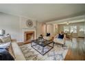 Comfortable living room with fireplace, hardwood floors, and views of the dining room at 1399 Pollard Sw Dr, Atlanta, GA 30311