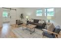Cozy living room with a comfortable gray sofa and hardwood flooring throughout at 4901 Prince Se Rd, Smyrna, GA 30082