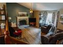 Cozy living room featuring a stone fireplace, hardwood floors, and comfortable seating at 114 Summer Glen Pl, Dallas, GA 30157