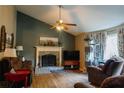 Warm living room with a vaulted ceiling, fireplace, and cozy seating area at 114 Summer Glen Pl, Dallas, GA 30157