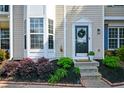 Inviting entryway with decorative wreath, fresh landscaping, and well-maintained front steps at 1575 Kilmington Ct, Alpharetta, GA 30009
